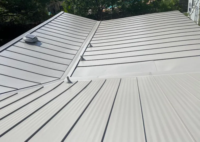 Solar attic fan installed on a metal roof for Roof Ventilation in East Orange
